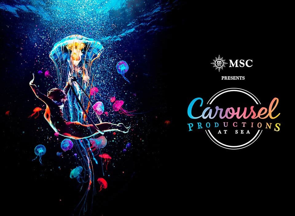A vibrant underwater-themed theatrical production featuring a performer suspended among